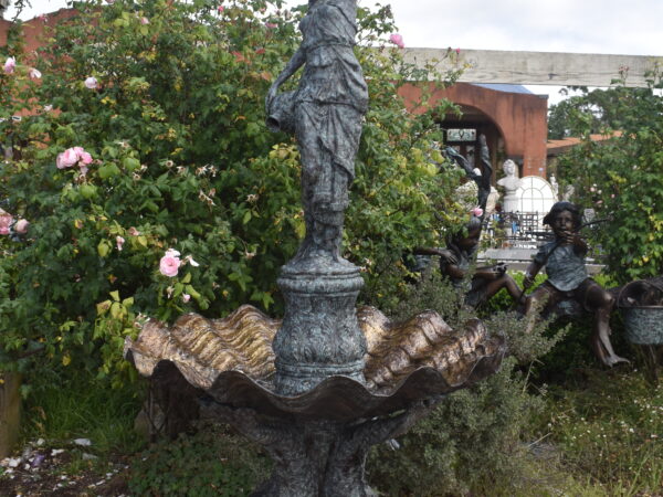 A large bronze fountain featuring a maiden with clam shell base.