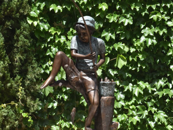  a bronze sculpture of a boy fishing, plumbed as a fountain.