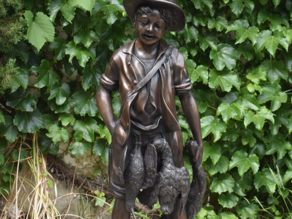  a bronze sculpture of a boy hunting
