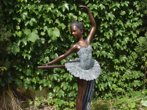 a bronze sculpture of a ballerina