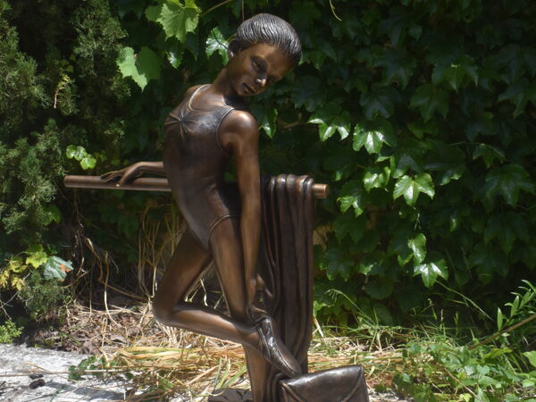 a bronze sculpture of a ballerina