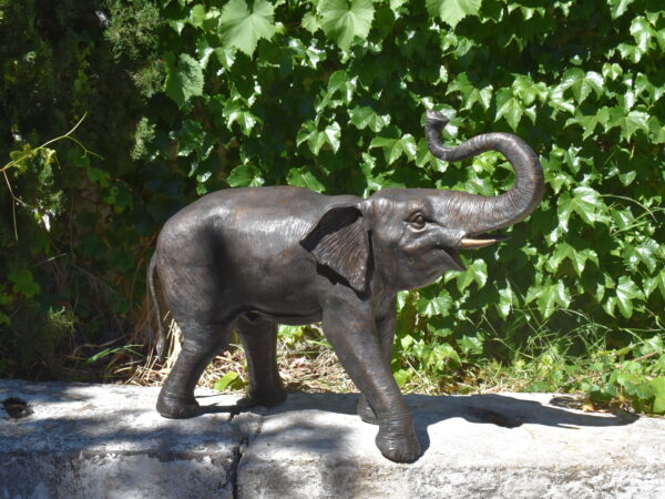 A bronze sculpture of an elephant, plumbed as a fountain
