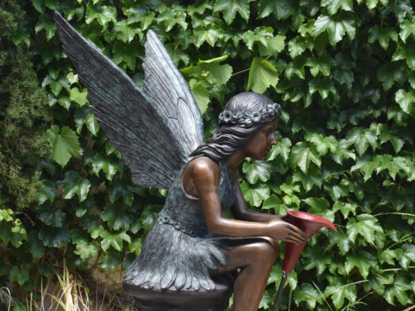 A large bronze fairy, plumbed as a fountain
