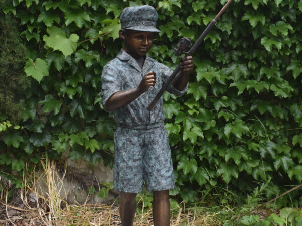 A wonderful bronze statue of a young boy fishing