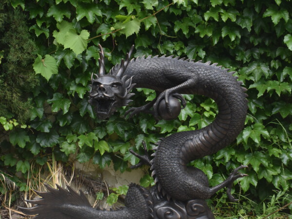 a large bronze dragon, plumbed as a fountain.