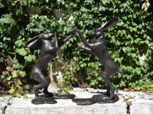 A pair of bronze boxing hares