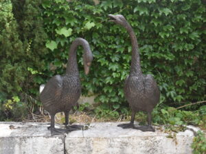 a pair of bronze geese plumbed as fountains
