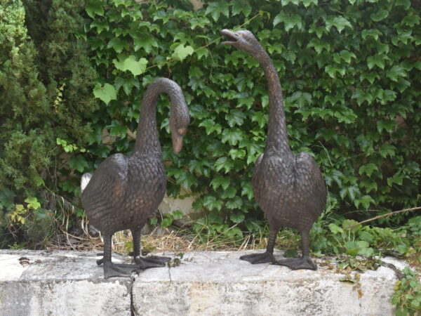 a pair of bronze geese plumbed as fountains