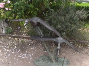 two bronze geese, plumbed as fountains.