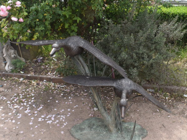 two bronze geese, plumbed as fountains.