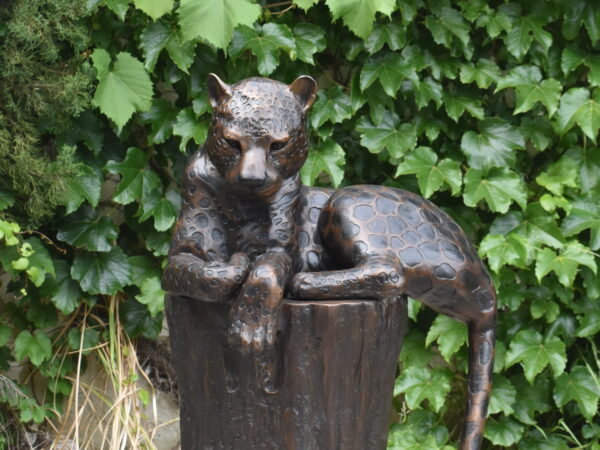 A bronze cheetah on a log,