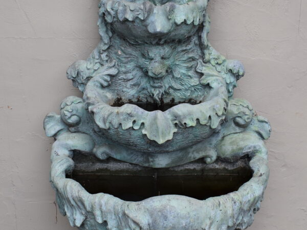 A bronze wall fountain.