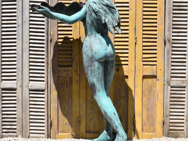 A bronze woman, plumbed as a fountain 