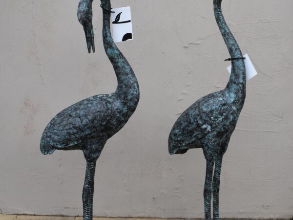 a pair of bronze cranes, plumbed as fountains. 