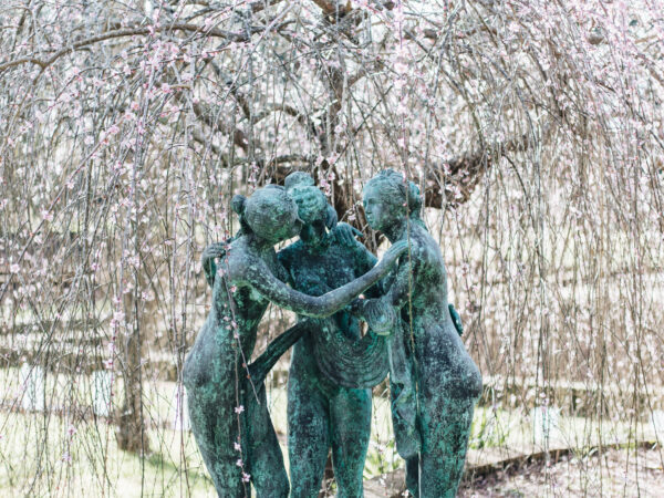 A large bronze statue of the three graces 