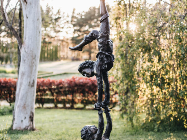 A bronze statue of two acrobatic children