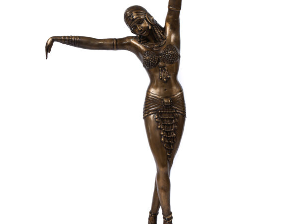 A bronze statue of an art deco style dancer