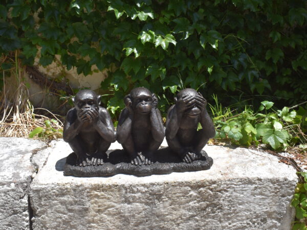 A bronze statue of 3 monkeys representing hear no evil, speak no evil, see no evil