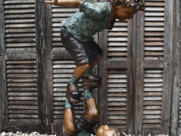 A delightful bronze statue of acrobatic children