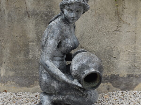 A bronze statue of a girl, plumbed as a fountain.